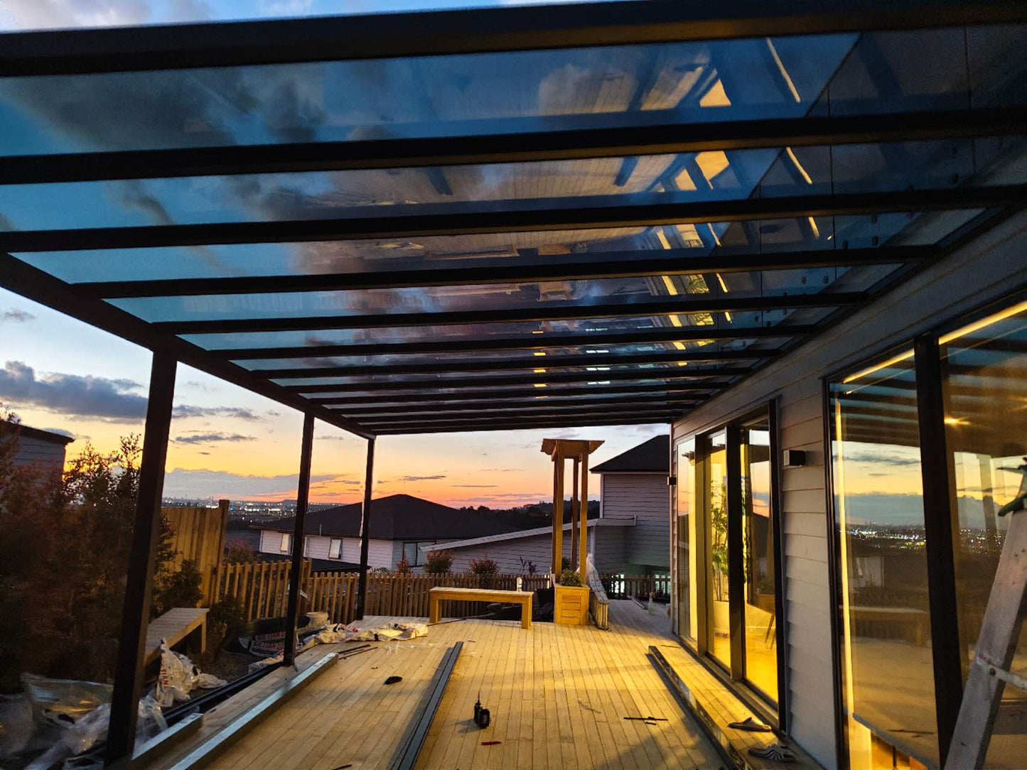 Grey polycarbonate pergola with black aluminum frame on the deck