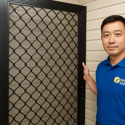 Person holding a black metal security mesh door.